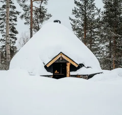 Lappish hut in winter in The Fell's yard covered in snow