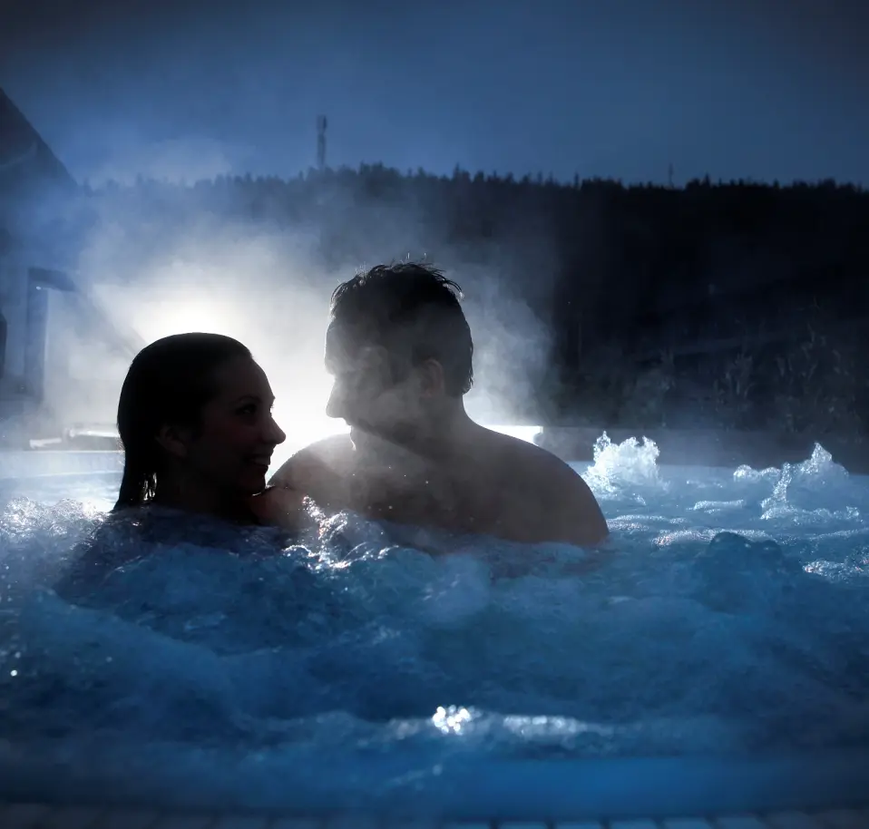 Couple in an outdoor jacuzzi at Levi Spa